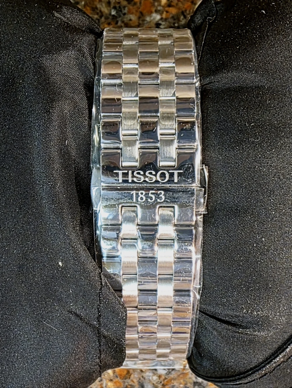 Tissot Silver Watch with Blue Hands and White Dial